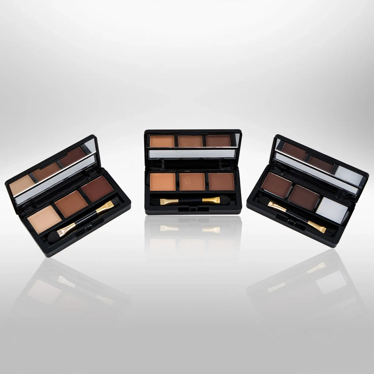 Three Malibu Glitz 3-color eyebrow palettes with built-in mirrors and brushes