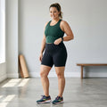 Fabletics women's black high-waisted athletic shorts in size XXL modeled indoors, front view